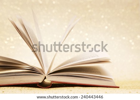 Open book, Open book on the sparkly vintage golden background