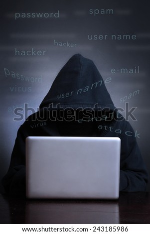 Silhouette of a hacker looking in monitor, Computer hacker - Male thief stealing data from laptop