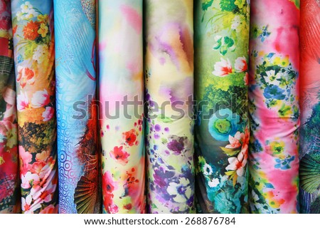 A variety of different bolts of colorful silk fabric