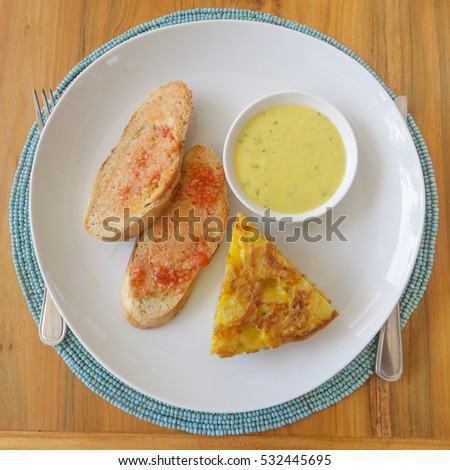 Top view of spanish potato tortilla, bread and sauce served on the plate
