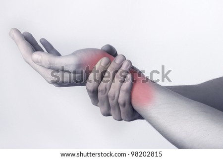 Wrist injury Man holds a hand on his pain wrist.