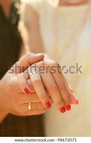 Happy couple  II Close-up photo of a caucasian couple\'s hands on their wedding day.