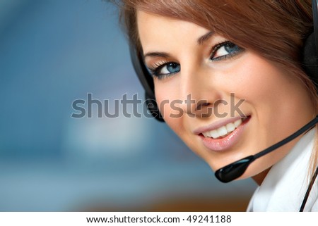 Beautiful representative smiling call center woman with headset.