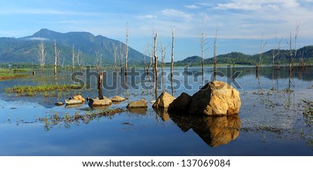 Scenic view of  with reflections of the blue sky and clouds, rocks in the water of Thailand