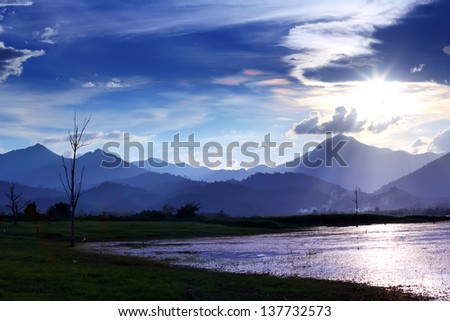 Iridescent cloud on the beautiful natural phenomenon with mountains nature background.