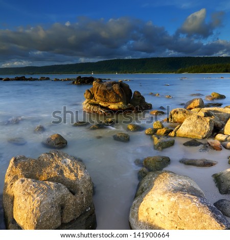 Summer of rocks in the sea at evening light, The natural landscape