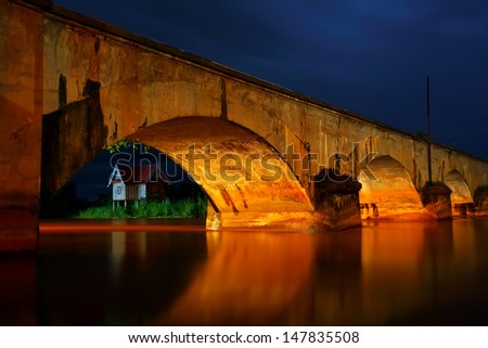 Old bridge on Don Khon Island with Mekong River at night in Champasak, Southern Laos