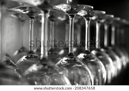 Rows of empty wine glasses on the showcase, black and white photography