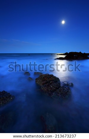 Rocks and sea under the moon shine after twilight,  Gulf of Thailand