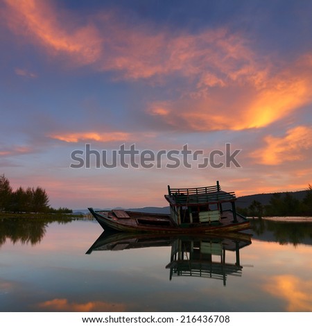 Fishing boat capsize in sunrise