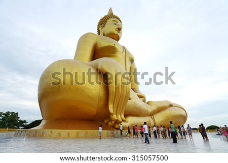 ANGTHONG, THAILAND - JUL 25: Unidentified people go to pray for big statue of buddha at Wat muang on July 25, 2010 in Angthong. It is a buddha statue sitting largest in Thailand