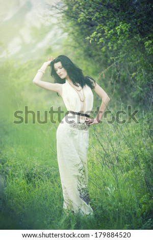 Portrait of beautiful sexy woman in field. Celtic style