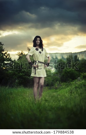 Portrait of beautiful sexy woman in field. Celtic style