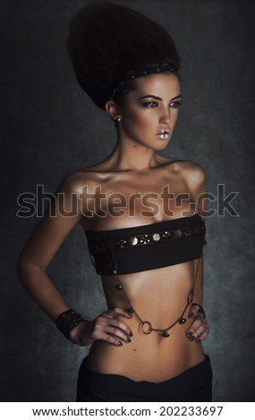 leather Jewellery. Beauty Brunette Egyptian Style Woman with Gold Accessories and Nails. Golden makeup