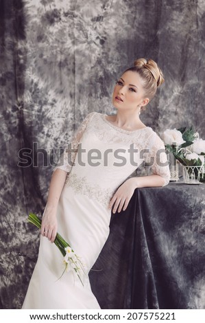Beauty woman with wedding hairstyle and makeup. Bride fashion. Jewelry and Beauty. Woman in white dress,perfect skin, blond hair. Girl with stylish haircut. Skincare.