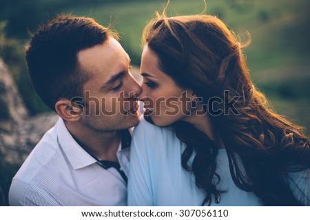 Young couple enjoying the sunset in the meadow. wedding style. romantic and love