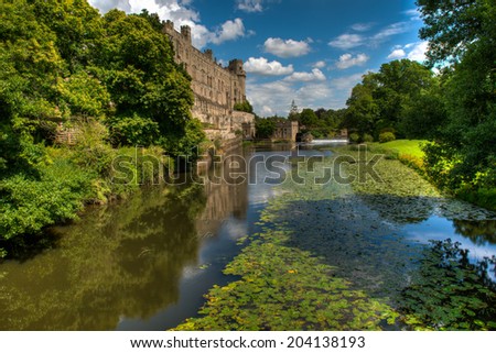 Warwick Castle and the river Avon in Warwick, England on a bright, sunny, summer day