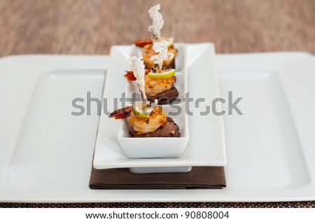 Surf and Turf Appetizers on a white plate with a napkin