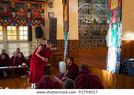 DHARAMSALA - DECEMBER 18: A Tibetan monk debates with his peers at the Dalai Lama Temple on December 18, 2009 in Dharamsala, India. Philosophical debate is a common practice amongst Tibetan monks.
