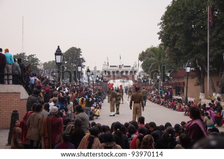 AMRITSAR - DECEMBER 19: Wagah border ceremony on December 19, 2009 in Amritsar, India. The India - Pakistan border closing ceremony is held each day and includes change of guards and retreat of flags.