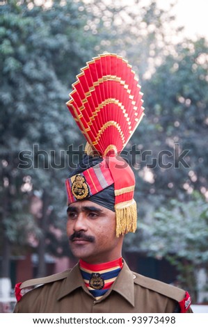 AMRITSAR - DECEMBER 19: An Indian guard at the Wagah border on December 19, 2009 in Amritsar, India. Guards participate in the changing of the guards at sundown, when the Pakistan border is closed.