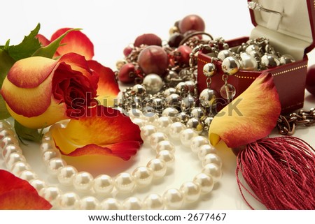 set of jewelries and flower over white background