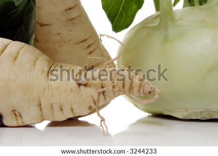 kohlrabi and parsley root over white background