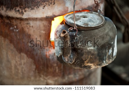 Flames boiling water in a sooty kettle at Muslim Street market in Xian, China