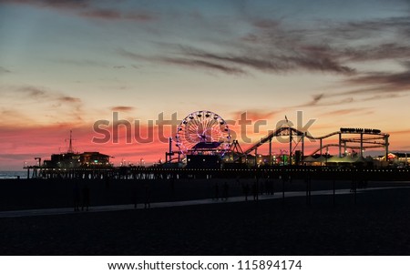 LOS ANGELES, USA - SEPTEMBER 22: Santa Monica Pier at dusk on September 22, 2012 in LA. The pier is a more than hundred-year-old historic landmark that contains Pacific Park, an amusement park.