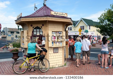 OAK BLUFFS, MA - June 22: Biker consults the tourist information on June 22, 2010 in Oak Bluffs at Martha\'s Vineyard. Oak Bluffs is one of the islands main points of arrival for summer tourists.