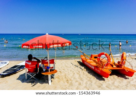 CEFALÃ?Â?, SICILY, ITALY Ã¢Â?Â? JULY 17: Lifeguard on duty at the beach on July 17, 2013 in CefalÃ?Â¹, Sicily. CefalÃ?Â¹ is one of the most popular destinations for a Sicilian vacation.