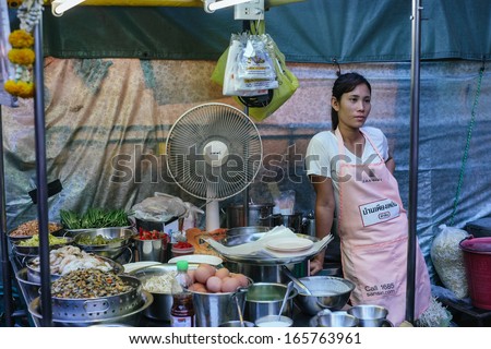 HUA HIN, THAILAND - FEBRUARY 27: Thai woman sells street food in a food stall at the night market on February 27, 2013 in Hua Hin. The famous night market in Hua Hin is a major tourist attraction.