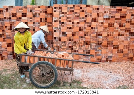 VINH LONG, VIETNAM - MARCH 7: Women work in a brickworks in the Mekong delta on March 7, 2009 near Vinh Long. The Mekong delta has become popular among tourists wishing to experience rural Vietnam.