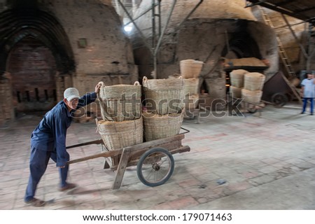 VINH LONG, VIETNAM - MARCH 7: Delivery of rice straw in a brickworks in the Mekong delta on March 7, 2009 near Vinh Long. Rice straw is used as fuel to heat the brick ovens.