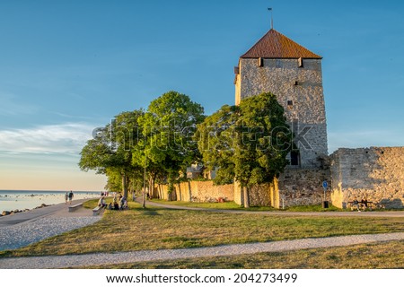 VISBY, SWEDEN - JUNE 10: Sunset at the famous medieval city wall and gunpowder tower on June 10, 2014 in Visby. The city wall from the 13th century is a Unesco World Heritage Site.