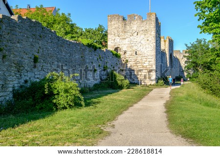 VISBY, SWEDEN - JUNE 10: Woman exercises outside the medieval city wall on June 10, 2014 in Visby. The famous city wall from the 13th century is a Unesco World Heritage site.