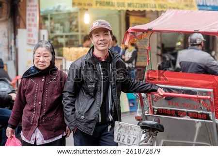 HANOI, VIETNAM   FEBRUARY 10: Rickshaw driver waits for customers in the old quarter on February 10, 2015 in Hanoi. The 36 old streets and guilds of the old quarter are a major tourist attraction.