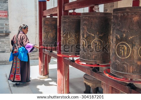 QINGHAI PROVINCE, CHINA â?? JUNE 25: Woman prays at Kumbum Monastery on June 25, 2012 in Qinghai Province. This Tibetan Buddhist monastery founded in 1583 ranks second only to Lhasa in importance.
