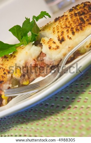 Shepherd's pie - minced (ground) meat topped with parsley mashed potato an baked golden brown