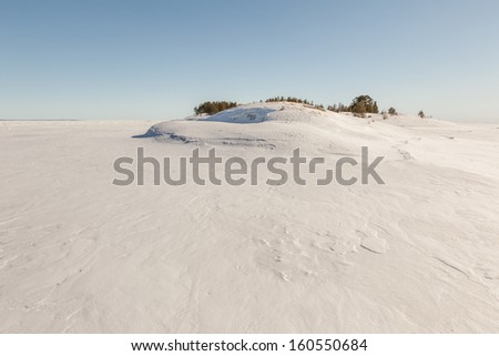 Winter, stony snow-covered island of Ladoga lake. A winter landscape. A panorama, winter landscape