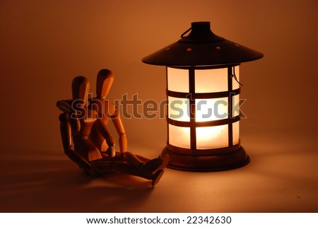 Sitting in front of a bright lantern on a dark night