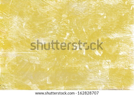 Scratched texture, uneven walls Designed background uneven patches of yellow wall