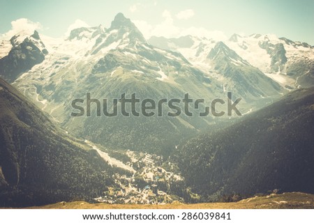 Mountain peaks landscape with a top view of the valley on a clear day. Caucasus mountains, North Caucasus
