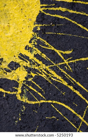 yellow paint on the black cement wall