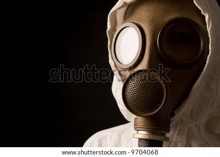 Person in gas mask on black background