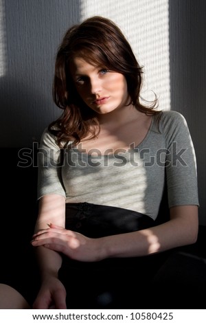 Portrait of young beautiful woman sitting on the sofa
