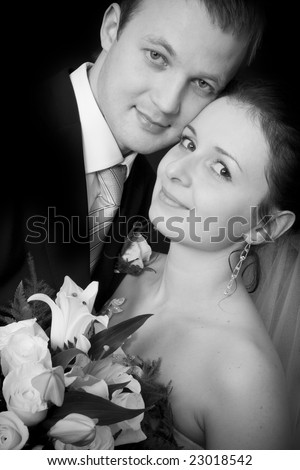 Bride and groom portrait on black background