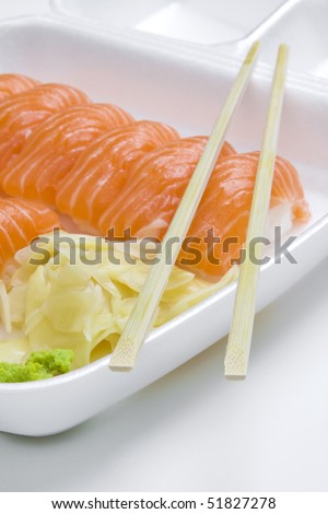 plastic white take-away box of salmon sushi