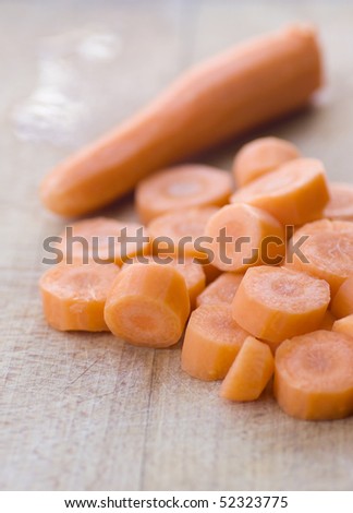 Chopped carrot in circles on wooden board
