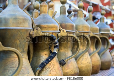 Arabic tea pots made of brass lined up for sale at the souk
